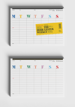 Two blank sheets from The Herb Lester Weekly planner shown from above, one with the yellow product band overlaid describing the planner's format and paper stock.